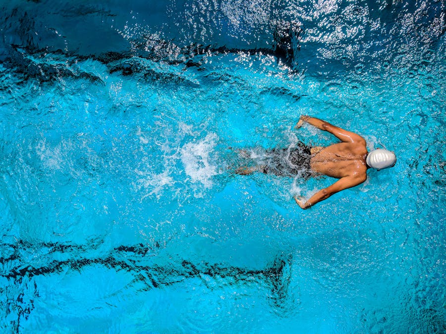 Aerial view of a competitive swimmer churning through the water